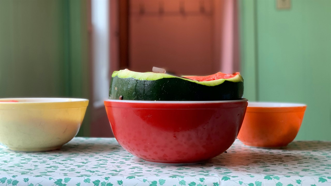 Half a watermelon in a red bowl